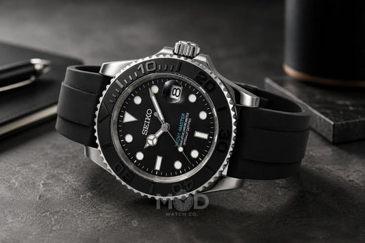 Seiko watch with black rubber strap on a dark surface