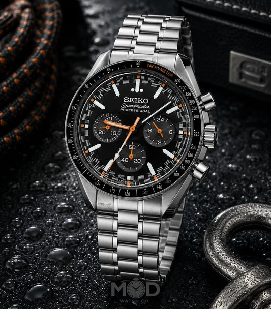Seiko watch with black dial and silver metal strap on a dark textured background