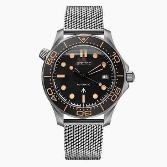 A Seiko automatic watch with a black dial, black rotating bezel, and a silver stainless steel mesh strap, shown against a light gray background.