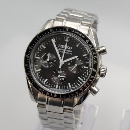 Silver Seiko watch with black dial on a white background