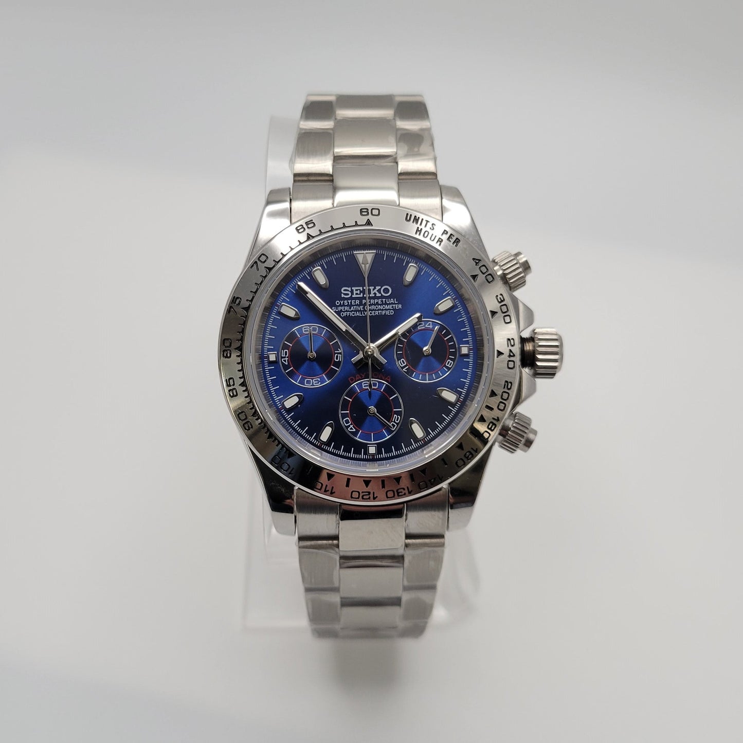 Silver Seiko watch with a blue face on a light gray background