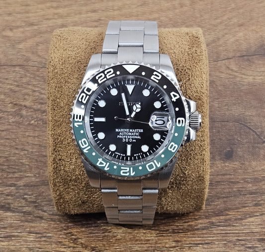Silver watch with black dial on a brown cushion against a wooden background