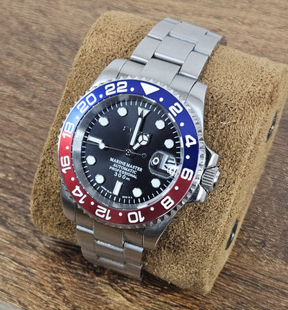 Watch with a silver bracelet on a brown cushion against a wooden background