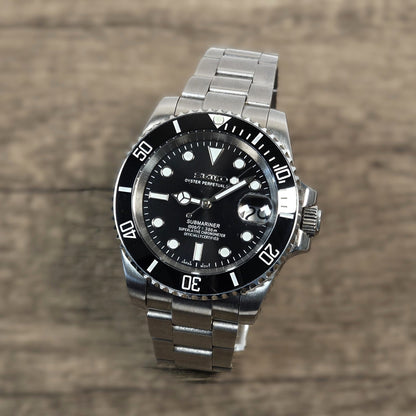 Silver watch with black dial on a wooden surface