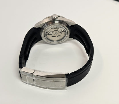 Watch with black strap and silver case on a white background