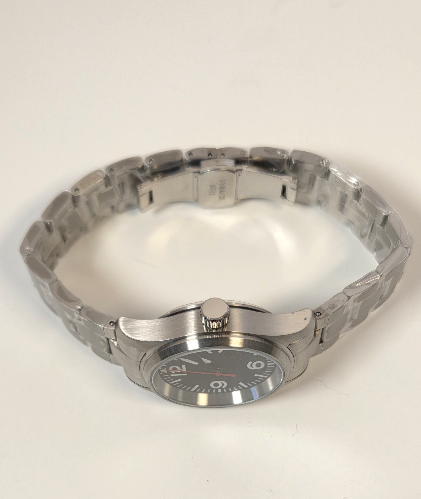 Silver watch on a light beige background
