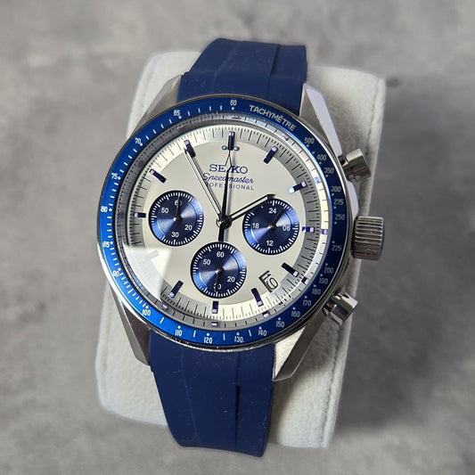Seiko watch with blue strap on a gray surface