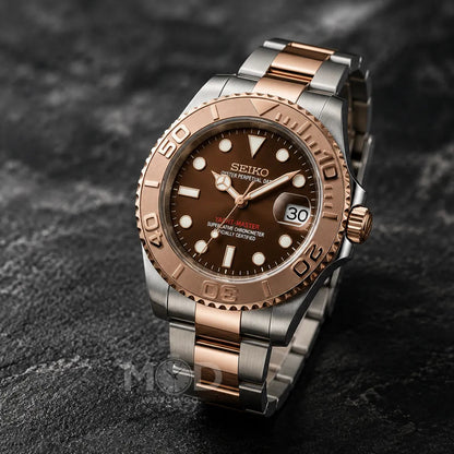 Seiko watch with brown dial and rose gold accents on a dark stone surface