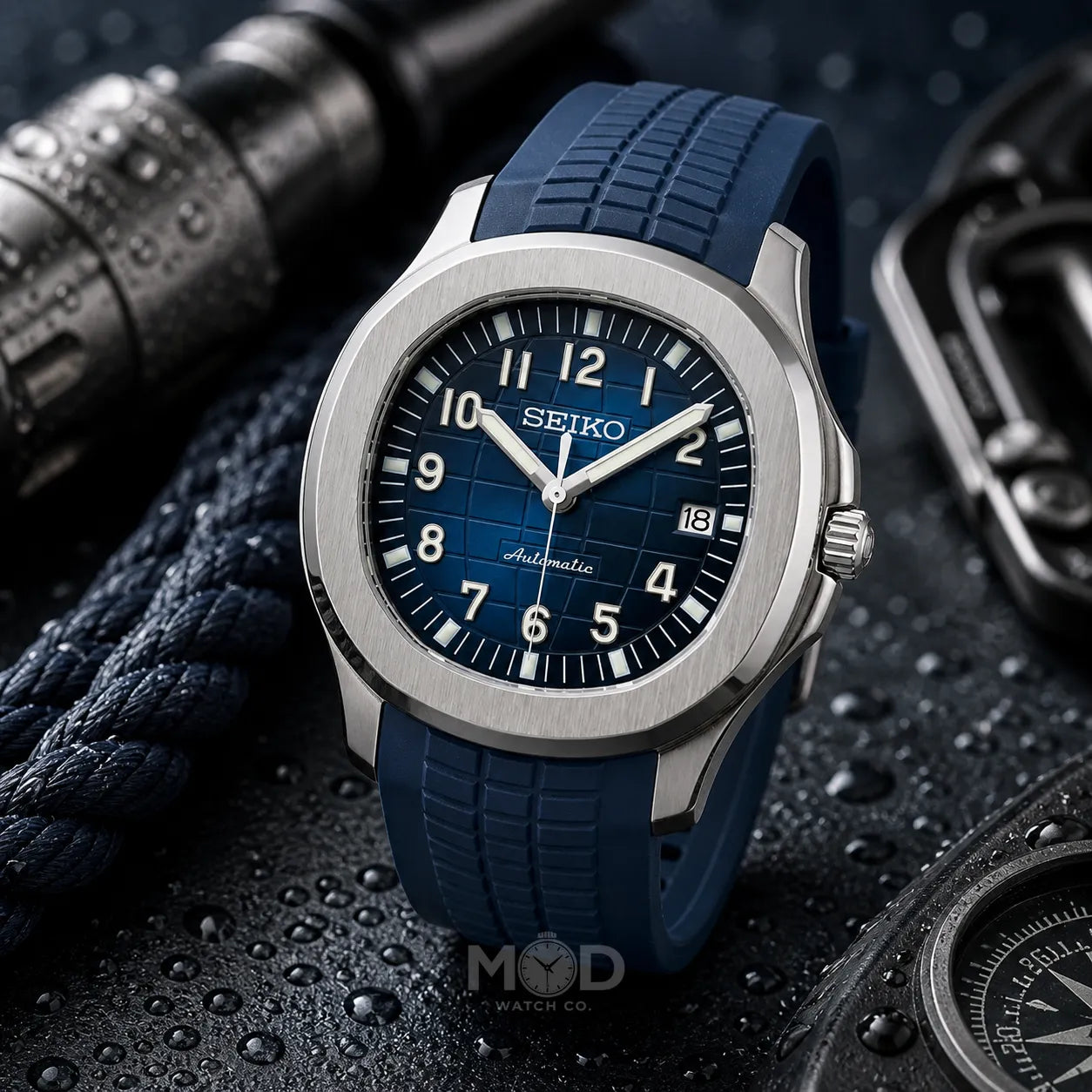 Seiko watch with blue strap on a textured dark background
