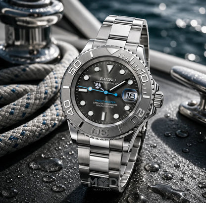 Silver Seiko watch on a textured surface with water droplets, yachts in the background