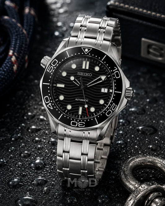 Seiko watch with a black dial and silver metal strap on a dark textured background