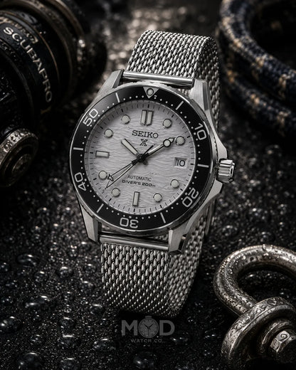 Seiko watch with a silver mesh strap on a dark textured background