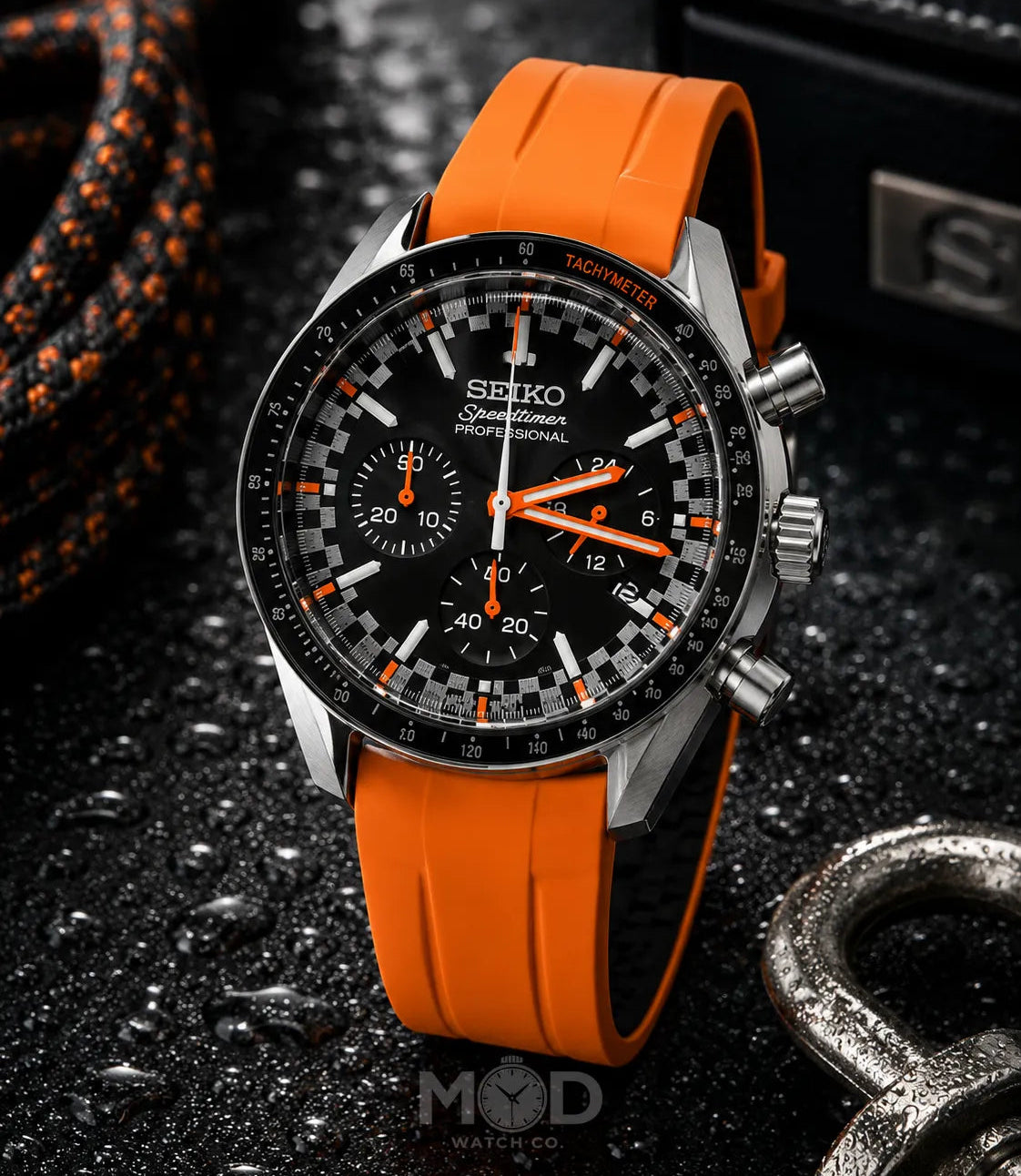 Seiko watch with orange strap on a dark textured background