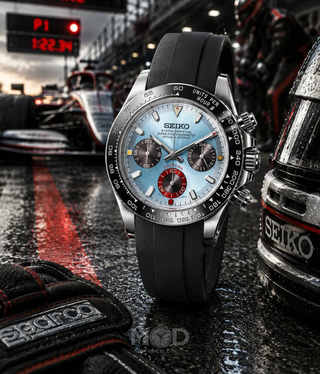 Seiko watch on a race track with racing car and gloves in the background