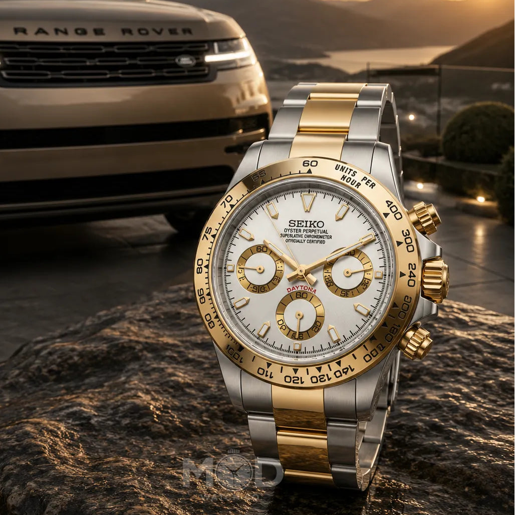 Luxury Seiko watch with gold and silver accents in front of a Range Rover vehicle.