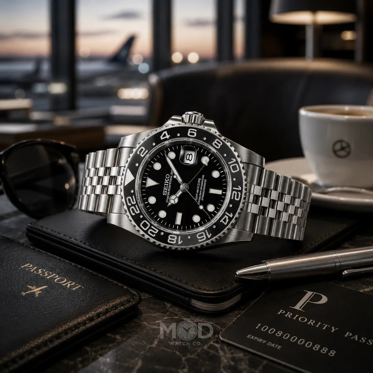 Luxury watch on a table with sunglasses, passport, and card in a blurred cafe setting