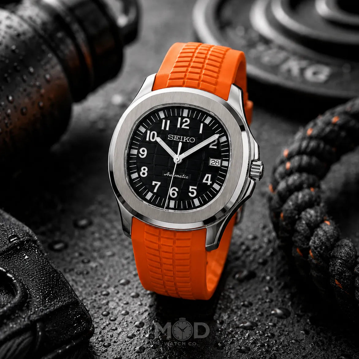 Seiko watch with orange strap on a dark textured background