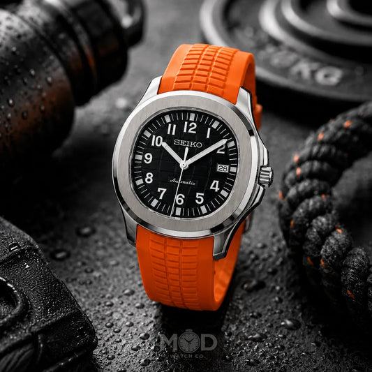Seiko watch with orange strap on a dark textured background