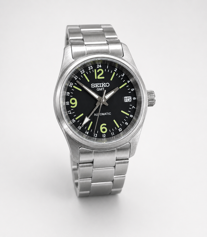 Seiko watch with black dial and silver metal strap on a white background