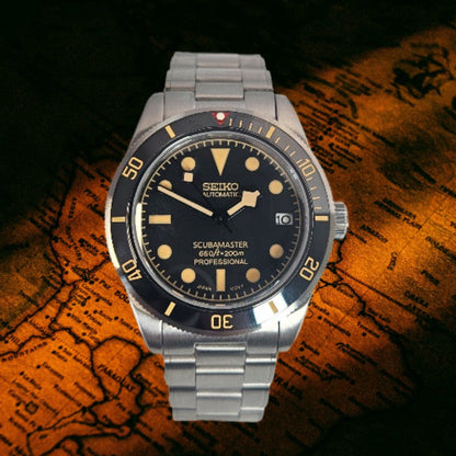 A Seiko Scubamaster 200m Professional wristwatch with a silver stainless steel case and bracelet, featuring a black dial with gold-toned indices and a black rotating bezel, displayed on an antique map background.