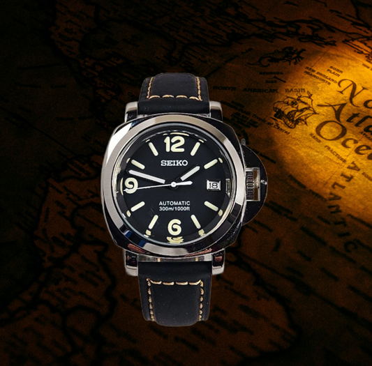 Seiko watch with black face and leather strap on a dark background