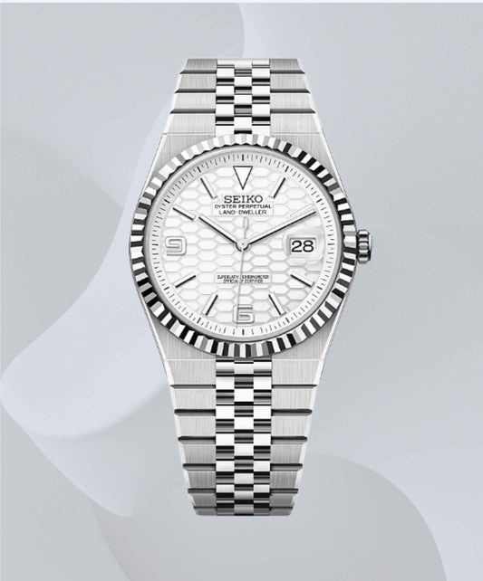 A Seiko stainless steel wristwatch with a fluted bezel, white textured dial, and matching steel link bracelet, shown against a light gray background with soft abstract wave shapes.