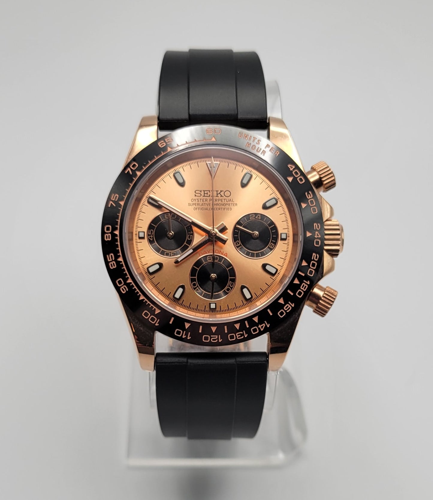 Seiko watch with black and rose gold design on a gray background