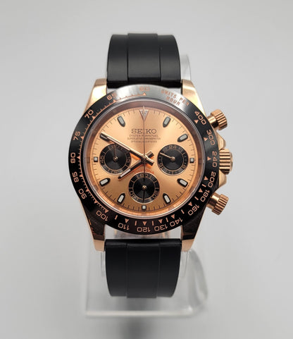 Seiko watch with black and rose gold design on a gray background